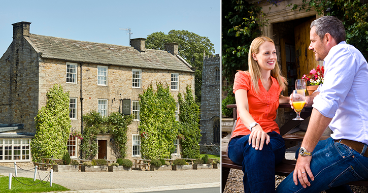 couple enjoying a drink in the outdoor seating area at the rose and crown inn Romaldkirk